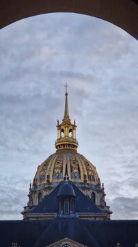 Close-up of the stunning golden dome of the Saint-Louis des Invalides Cathedral in Paris, France. Ornate spire and gilded roof, architectural masterpiece