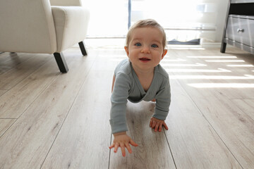 Baby crawling on the floor. Copy space, background.