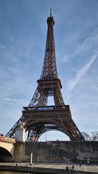 Cruise boat perspective along the Seine in Paris with a great view to the Eiffel Tower as passing underneath the Pont d'Iena bridge. Parisian landmark as global attraction. French trip symbol