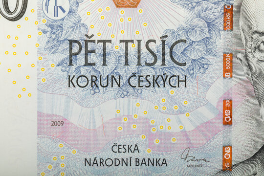 A detailed image showcases a section of a 5000 Czech Korun banknote, featuring the denomination inscription with abstract floral pattern. The banknote was issued in 2009.