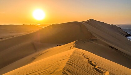 Golden Desert Dunes Under a Brilliant Sunset with Ocean Horizon