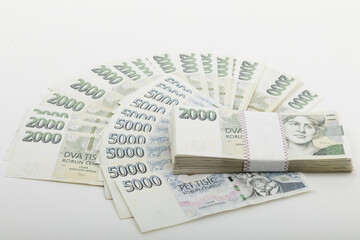 Arrangement of Czech Koruna banknotes, including denominations of 2000 and 5000 CZK, displayed on a flat surface, Czech Republic.