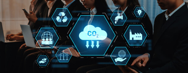 Business professionals engage with digital devices while analyzing carbon footprint icons, emphasizing the importance of sustainability and CO2 reduction in modern enterprises. Trope