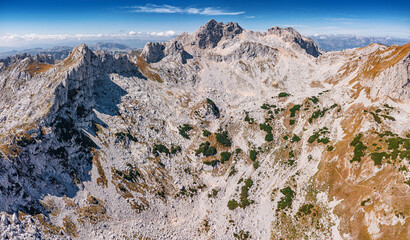 Aerial view showing rocky mountain Bobotov Kuk in Durmitor, Montenegro, with sparse green...