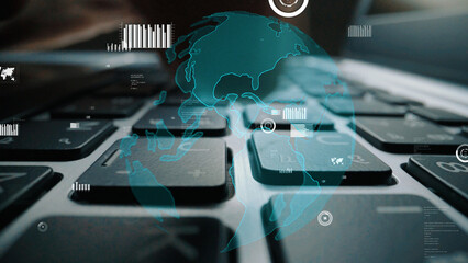 This close-up image of a laptop keyboard features digital graphics of the Earth and data visualizations, symbolizing global connectivity and the impact of technology. Xenic