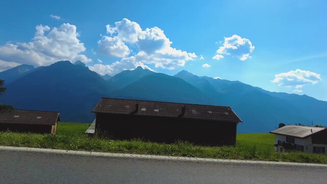 Driving around the swiss alps in the village schmitten on a sunny day in summer