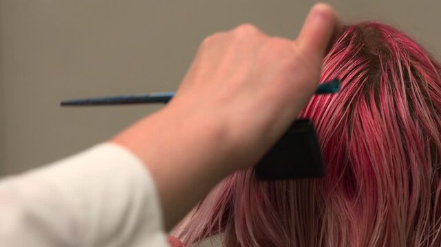 Stylist Shaping Layered Pink Hair, Professional Stylist Carefully Snipping Pink Dyed Hair Into Layers. Media