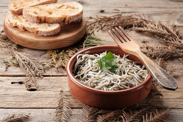 Gulas Served in a Bowl With Bread on a Wooden Table Surrounded by Leaves