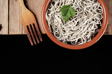 Gulas in a bowl with a wooden fork on a rustic table