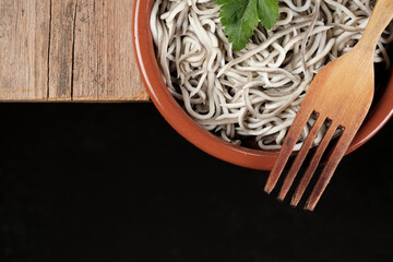 Gulas in a bowl with a wooden fork on a rustic table