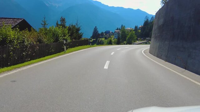 Driving around the swiss alps in the village schmitten on a sunny day in summer