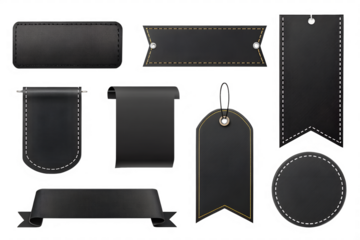 This image showcases a diverse assortment of black leather labels and tags, each with unique designs and stitching details. The collection includes various shapes such as rectangular, pennant