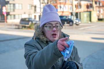 Outdoor portrait of a 43-year-old woman with Down Syndrome, cozy winter setting