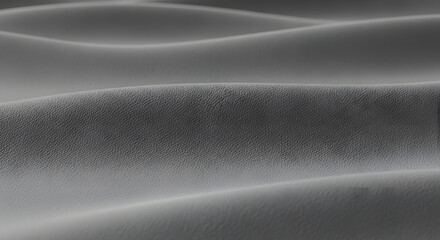 Abstract background texture showcasing repeating smooth gray waves and subtle granular surface detail creating a monochromatic landscape effect suitable for overlays or minimalist design.