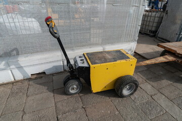 Small electric tow tractor for carts in industrial area