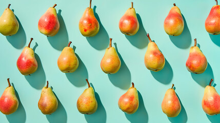 Minimalist flat lay of ripe pears on a vibrant turquoise background for modern design