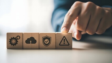 A hand interacting with wooden blocks featuring various security and warning symbols