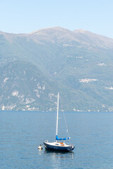 Views of lake Como with blue water, alpine mountains, beautiful villages, travel destination in North of Italy