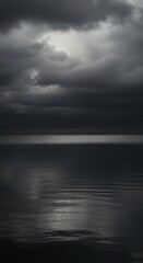 Obraz premium Moody, expansive gray water reflecting a heavily overcast sky, creating a somber, monochrome marine landscape ,bluish ,wave ,marine