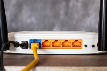 White router with a yellow cable coming out of it