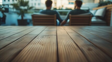 Two young men sit together on a wooden deck, enjoying a moment of connection. The background features a blurred urban setting, evoking a sense of love and intimacy.