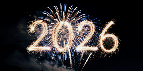 Festive fireworks illuminate the night sky, crafting a sparkling '2026' for a joyful New Year's celebration and future aspirations
