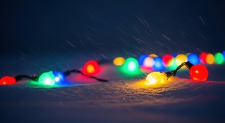 Heavy snowfall obscures festive outdoor holiday lights against a deep dark winter evening sky creating a cold, isolated atmosphere, christmas, night, isolated