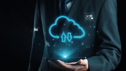 A businessman holds a smartphone displaying digital cloud technology icons, illustrating concepts of data transfer, security, and innovative storage solutions in a modern setting. Qubit - Powered by Adobe