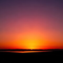 Fototapeta premium Stunning golden hour sky over a peaceful landscape silhouette, featuring vibrant sunset colors, tranquil horizon, and serene evening light, purple, golden hour, tranquil