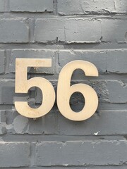 56 on a brick wall