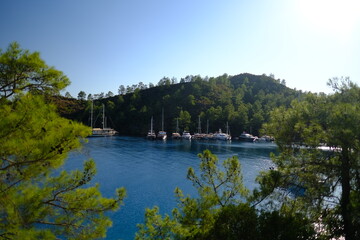 Fototapeta premium Scenic view of Göcek, a picturesque coastal town on the Turkish Riviera which known for its modern marinas, luxury yachts, and surrounding islands and bays in Fethiye, Turkey.