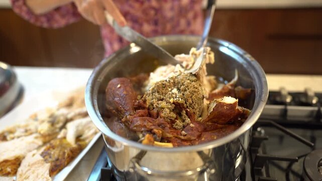 Senior woman serving stuffing on a platter with turkey in a home kitchen