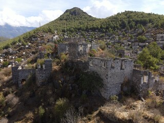 Fototapeta premium Aerial view of Kayaköy, a historic abandoned village set on a hillside near Fethiye, Turkey