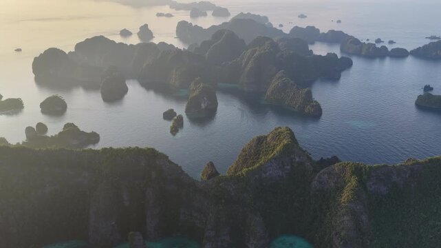 Beautiful rock islands, composed of ancient, uplifted reefs, rise from the seascape in Misool, Indonesia. This region harbors spectacular marine biodiversity and is a popular diving destination.