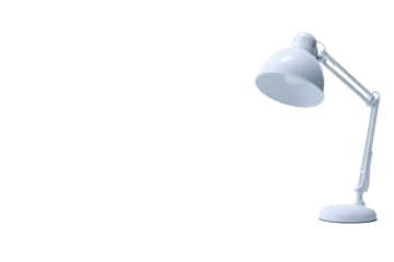 Desk lamp stands on white surface illuminating workspace in a home office setting during the day