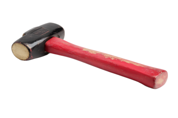 Hammer with a black head and red handle placed on a white surface ready for use in a workshop setting