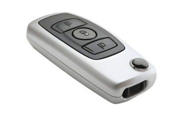 Key fob lying on a flat surface, showing buttons for locking, unlocking, and trunk release for a vehicle