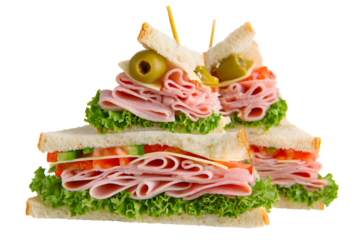 Sandwiches stacked with lettuce, tomatoes, and slices of ham placed on a white background during a meal preparation