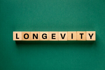 The word Longevity written on wooden blocks. The concept of longevity. Eating habits, positive...