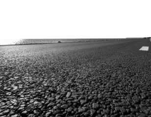 Low-angle asphalt road disappearing to the horizon