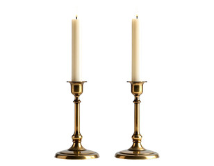 Two lit candles in brass candlesticks, dark background