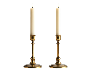 Two lit candles in brass candlesticks, dark background