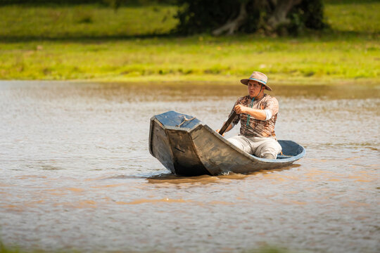 Man paddling canoe on river in Casanare, Colombia