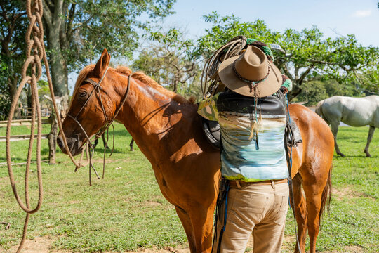 Man saddling horse in rural Casanare, Colombia
