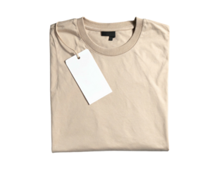 Folded beige tee shirt, blank tag, dark label