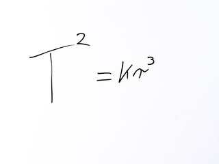 Minimal handwritten “T²   Kr³” on white background. Concept symbolizing Kepler’s third law relating orbital period and orbital radius. © Michal