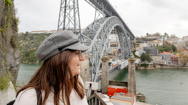 Woman smiling near Don Luis I Bridge and Douro River