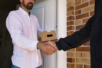 Delivery boy handing a parcel to a recipient