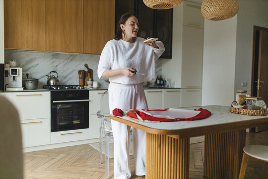 Woman preparing red sweater as part of a hobby project