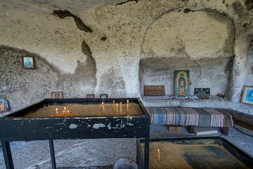 Orthodox Cave Chapel with Icon Altar and Candles